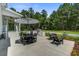Outdoor patio with an umbrella-covered table, a grill, and comfortable seating, perfect for entertaining at 105 Bobcat Ln, Ravenel, SC 29470