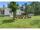 Charming backyard with a circular landscaped garden, patio seating, and lush green lawn at 105 Bobcat Ln, Ravenel, SC 29470