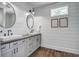 Bathroom featuring double sinks, white shiplap walls, and modern fixtures at 105 Bobcat Ln, Ravenel, SC 29470