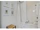 Bathroom with white subway tile, soaking tub, and framed botanical prints on the wall at 105 Bobcat Ln, Ravenel, SC 29470