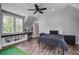 Spacious bedroom with wood floors, bright windows, a ceiling fan and a built-in study desk at 105 Bobcat Ln, Ravenel, SC 29470