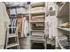 Custom walk-in closet with clothing racks, shelves, baskets, drawers, and ladder for easy access at 105 Bobcat Ln, Ravenel, SC 29470