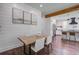 Charming dining area with wood beam, seamlessly connected to a modern kitchen at 105 Bobcat Ln, Ravenel, SC 29470
