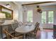 Elegant dining area featuring a chandelier, French doors, and stylish decor at 105 Bobcat Ln, Ravenel, SC 29470