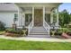 Charming front porch with stone accents, elegant planters, and a welcoming entrance at 105 Bobcat Ln, Ravenel, SC 29470