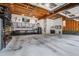 Well-lit garage with exposed wooden beams, a concrete floor, and ample storage space at 105 Bobcat Ln, Ravenel, SC 29470