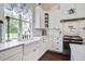 Classic kitchen design featuring white cabinets, marble countertops, and a farmhouse sink at 105 Bobcat Ln, Ravenel, SC 29470