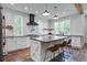 Bright kitchen featuring white cabinets, a center island, and hardwood floors at 105 Bobcat Ln, Ravenel, SC 29470