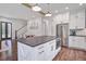 Kitchen island in an open layout with hardwood floors and white cabinetry at 105 Bobcat Ln, Ravenel, SC 29470