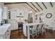 Bright kitchen boasts white cabinets, a marble island with seating, and stainless steel appliances at 105 Bobcat Ln, Ravenel, SC 29470