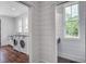Convenient laundry room features side-by-side washer and dryer units with hardwood flooring at 105 Bobcat Ln, Ravenel, SC 29470