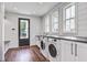 Bright laundry room featuring side-by-side washer and dryer units and a bench by the back door at 105 Bobcat Ln, Ravenel, SC 29470