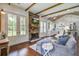 Inviting living room with hardwood floors, a stone fireplace, and plenty of natural light at 105 Bobcat Ln, Ravenel, SC 29470