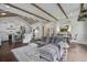 Comfortable living room featuring wood beams, hardwood floors, and an open floor plan to the kitchen at 105 Bobcat Ln, Ravenel, SC 29470
