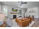 Bright living room featuring shiplap walls, fireplace, and hardwood floors at 105 Bobcat Ln, Ravenel, SC 29470