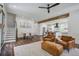 Open-concept living area with staircase and hardwood flooring, seamlessly flowing to kitchen at 105 Bobcat Ln, Ravenel, SC 29470