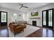 Open-concept living room with fireplace, modern ceiling fan, and hardwood floors at 105 Bobcat Ln, Ravenel, SC 29470