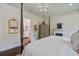 Spacious main bedroom with hardwood floors, four poster bed, chandelier, sitting area, and fireplace at 105 Bobcat Ln, Ravenel, SC 29470