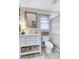 Bright bathroom featuring a white vanity, wooden mirror, and striped shower curtain at 109 Fort St, Summerville, SC 29485