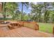 Wood deck with bench seating and stairs leading to the large backyard at 109 Fort St, Summerville, SC 29485