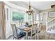 Inviting dining room with a large window, a modern chandelier, and views of the backyard at 109 Fort St, Summerville, SC 29485