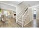 Bright foyer with staircase leading to a cozy living room with a fireplace, creating a warm and inviting atmosphere at 109 Fort St, Summerville, SC 29485