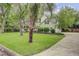 Beautiful home with lush green lawn, complemented by mature palm trees and a long driveway at 109 Fort St, Summerville, SC 29485