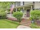 Charming front porch with an American flag and lush landscaping, creating a welcoming entrance at 109 Fort St, Summerville, SC 29485
