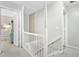 Upstairs hallway with white railings and trim, leading to various rooms in the house and plenty of light at 109 Fort St, Summerville, SC 29485
