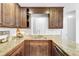 Modern kitchen with granite countertops, dark wood cabinetry, and stainless steel sink fixture at 109 Fort St, Summerville, SC 29485