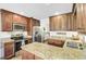Bright kitchen features granite countertops, stainless steel appliances, and dark wood cabinets at 109 Fort St, Summerville, SC 29485