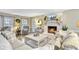 Comfortable living room featuring a whitewashed brick fireplace, wood floors, and ample natural light at 109 Fort St, Summerville, SC 29485