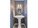 Charming powder room featuring bold wallpaper, a pedestal sink, and elegant lighting, adding character to the space at 109 Fort St, Summerville, SC 29485