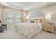 Comfortable bedroom with neutral tones, large windows, and decorative wall art above the headboard at 109 Indigo Cove Blvd, Summerville, SC 29486