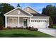 Charming single-Gathering home features a landscaped front yard, a covered porch, and a two-car garage with a green front door at 109 Indigo Cove Blvd, Summerville, SC 29486