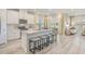 Modern kitchen features an island with seating, stainless steel appliances, white cabinets, and lots of natural light at 109 Indigo Cove Blvd, Summerville, SC 29486
