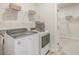 Modern laundry room with updated washer and dryer units and built-in storage shelves at 109 Indigo Cove Blvd, Summerville, SC 29486