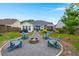 Inviting backyard with a cozy fire pit and ample seating for outdoor relaxation and entertainment at 1103 Cates Ct, Summerville, SC 29483