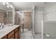 Modern bathroom featuring a tiled shower with glass doors, a double sink vanity, and updated fixtures at 1103 Cates Ct, Summerville, SC 29483