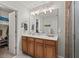 Bathroom featuring a vanity with wood cabinets, white countertop, and a mirror with modern lighting fixtures at 1103 Cates Ct, Summerville, SC 29483