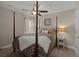 Bedroom with a four-poster bed, neutral walls, white curtains, and a decorative ceiling fan at 1103 Cates Ct, Summerville, SC 29483