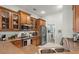 Charming kitchen featuring wood cabinets, stainless steel appliances, and convenient access to the laundry area at 1103 Cates Ct, Summerville, SC 29483