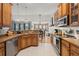 Functional kitchen with wood cabinetry, stainless steel appliances, and an inviting view of the dining area at 1103 Cates Ct, Summerville, SC 29483