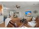 Comfortable living room with hardwood floors, ceiling fan, a media center, and open views to the dining room at 1103 Cates Ct, Summerville, SC 29483