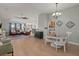 Open living space with hardwood floors, a ceiling fan, and seamless flow between dining and living areas at 1103 Cates Ct, Summerville, SC 29483