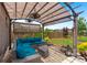Covered patio with stylish outdoor seating, string lights, and a peaceful view of the backyard at 1103 Cates Ct, Summerville, SC 29483