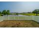 Relaxing backyard view of pond, surrounded by lush greenery at 112 Lake Jogassee Dr, Summerville, SC 29485