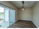Open dining area with modern light fixture and sliding door to patio at 112 Lake Jogassee Dr, Summerville, SC 29485