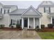 Charming townhome with gray siding, black shutters, white columns, and manicured landscaping at 112 Lake Jogassee Dr, Summerville, SC 29485