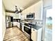 The kitchen features stainless steel appliances, modern cabinets, and hardwood floors at 112 Lake Jogassee Dr, Summerville, SC 29485